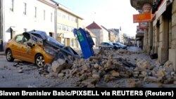 Croatia, Sisak, A destroyed car is seen on a street after an earthquake