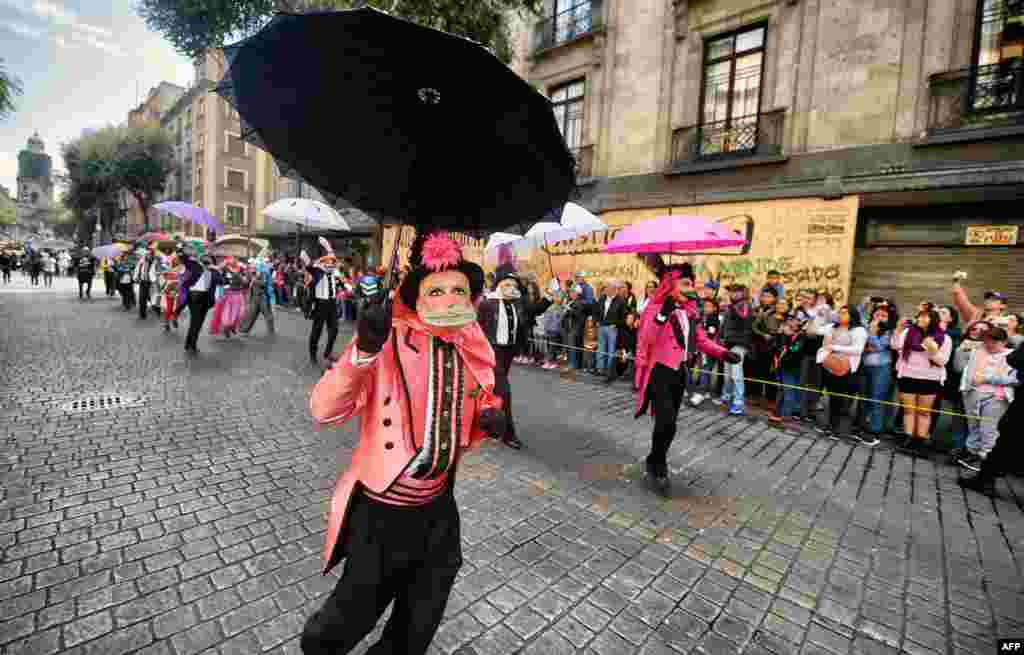 Dancers dressed in traditional costumes take part in the tenth Monumental &quot;Alebrijes&quot; Parade and contest organized by the Folk Art Museum, Oct. 20, 2018 in Mexico City.