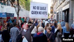 Martin Sagrera, 83, Catalonian retiree living in Madrid, holds a sign that reads "Don't complain if you don't vote" ahead of the April 28 Spanish general election, in downtown Madrid, April 27, 2019.