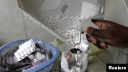 FILE - Anti-retroviral (ARV) drugs are dispensed by a pharmacist at a hospital in Kenya's capital Nairobi, Sept. 10, 2015. 