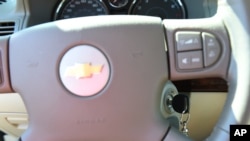 FILE - A photo shows the steering wheel and ignition switch on a 2005 GM-produced Chevrolet Cobalt.