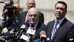 U.S. Rep. Michael Grimm, right, speaks to the media outside of federal court in New York, April 28, 2014.