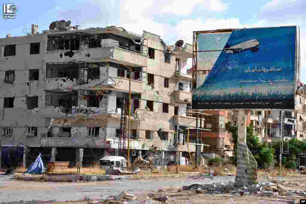 This citizen journalism image provided by Lens Young Homsi shows buildings damaged by fighting between rebel fighters and Syrian government forces in Homs province, Syria, June 18, 2013. 