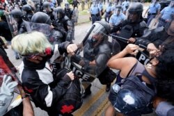 Police clear the streets of some demonstrators during a protest, in Stone Mountain Village, Georgia, Aug. 15, 2020.