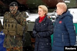 German Minister of Defense Ursula von der Leyen and Lithuanian President Dalia Grybauskaite, right, visit German troops deployed as part of NATO enhanced Forward Presence battle group in Rukla military base, Lithuania, Feb. 4, 2019.
