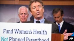 Senator Rand Paul, R-Ky. (Center), with Senators John Cornyn, R-Texas (Left), and John Thune, R-S.D., speaks about Planned Parenthood, on Capitol Hill in Washington, July 29, 2015.
