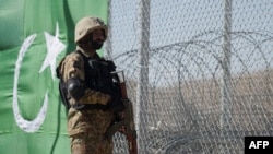 A Pakistani soldier keeps vigil next to a newly fenced border fencing along with Afghan's Paktika province border in Angoor Adda in Pakistan's South Waziristan tribal agency on October 18, 2017.