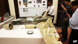 FILE - Photographers take pictures of what officials described as an Iranian Qasef drone captured on the battlefield in Yemen during a news conference in Abu Dhabi, United Arab Emirates, June 19, 2018. 