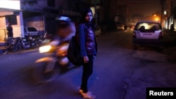 Sheetal, 23, who works at a night call center, poses for a photograph outside her office in New Delhi, January 12, 2013. 