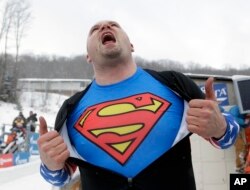 United States' Steven Holcomb celebrates after driving to a win with brakeman Steven Langton in the two-man bobsled World Cup event, Dec. 13, 2013, in Lake Placid, New York.