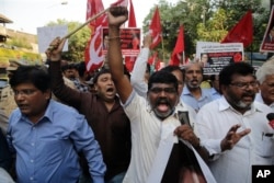 Members of Dalit organisations and leftist groups shout slogans as they hold placard during a protest in Mumbai, India, April 2, 2018.