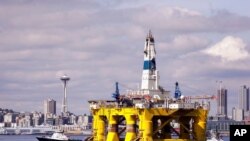 FILE - The oil drilling rig Polar Pioneer is towed toward a dock and in view of the Space Needle in Elliott Bay in Seattle, May 14, 2015. Researchers say the hammering of oil drills creates noise pollution that harms sea life.