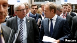 European Commission President Jean-Claude Juncker and European Council President Donald Tusk (R) arrive to address a joint news conference on the second day of the EU Summit in Brussels, Belgium, June 29, 2016. 