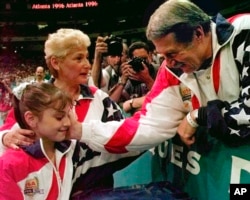 FILE - Bela Karolyi congratulates Dominique Moceanu aft  the United States captured the golden  medal successful  the women's squad  gymnastics contention  astatine  the Centennial Summer Olympic Games successful  Atlanta, July 23, 1996.