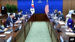 In this photo provided by South Korea Foreign Ministry, U.S. Deputy Secretary of State Wendy Sherman, right, holds talks with South Korean First Vice Foreign Minister Choi Jong Kun, left, during their meeting in Seoul, South Korea, July 23, 2021.