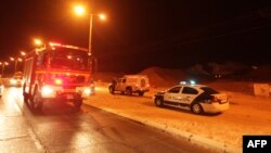 Police and rescue services arrive at the scene of a rocket attack in the Israeli Red Sea resort of Eilat, on August 15, 2012.