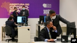 Armed Forces representatives inspect coding of electronic voting machines that will be used for elections, at the Source Code Inspection Department of the Supreme Electoral Court in Brasilia, Brazil, Aug. 3, 2022.