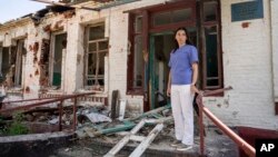 Seorang dokter berdiri di depan departemen terapi yang hancur dalam serangan Rusia terhadap sebuah rumah sakit di Zolochiv, wilayah Kharkiv, Ukraina, 31 Juli 2022. (Foto: AP)