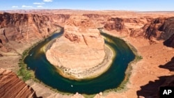 FILE - The Colorado River flows at Horseshoe Bend in the Glen Canyon National Recreation Area, in Page, Arizona, June 8, 2022. (AP Photo/Brittany Peterson, File)