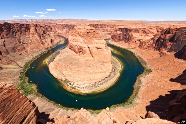 FILE - The Colorado River flows at Horseshoe Bend in the Glen Canyon National Recreation Area, in Page, Arizona, June 8, 2022.