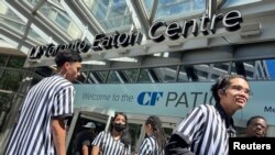 Athletics store staff are turned away from entering Eaton Centre shopping mall during an power outage in Toronto, Ontario, Canada, Aug. 11, 2022. 