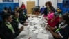 Election officials count votes at a polling station in Kilimera Primary School in Nairobi, Kenya, Aug. 9, 2022. 