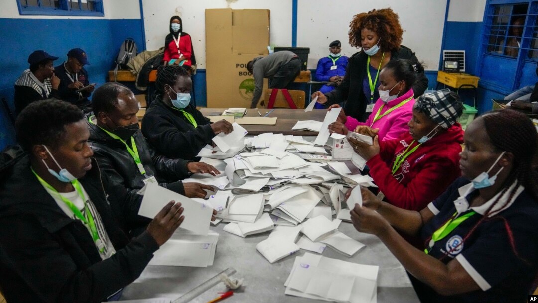 Election officials count votes at a polling station in Kilimera Primary School in Nairobi, Kenya, Aug. 9, 2022. 