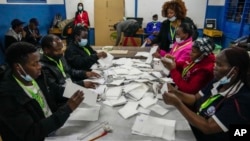 Election officials count votes at a polling station in Kilimera Primary School in Nairobi, Kenya, Aug. 9, 2022. 