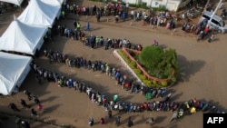 Voters queue to vote during Kenya's general election at the M.V Patel hall polling station in Eldoret on Aug. 9, 2022.