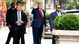 Former President Donald Trump gestures as he departs Trump Tower, Wednesday, Aug. 10, 2022, in New York, on his way to the New York attorney general's office for a deposition in a civil investigation.