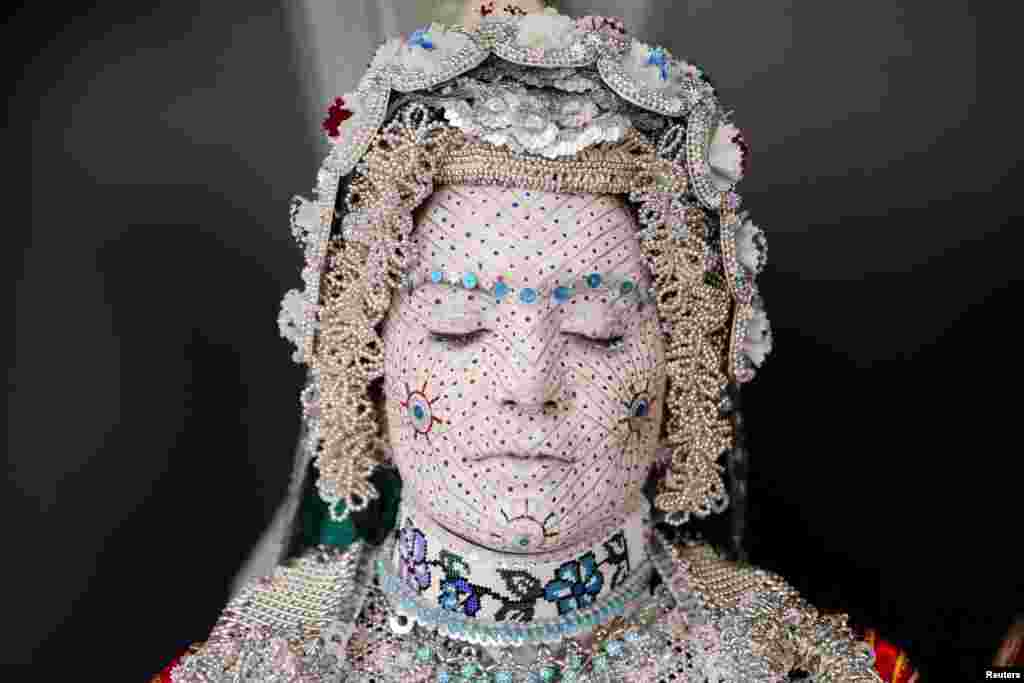 Melissa Guerrero, a U.S. citizen of Mexican origin, wears traditional wedding makeup and a traditional costume during her wedding ceremony in the village Donje Ljubinje, near Prizren, Kosovo.