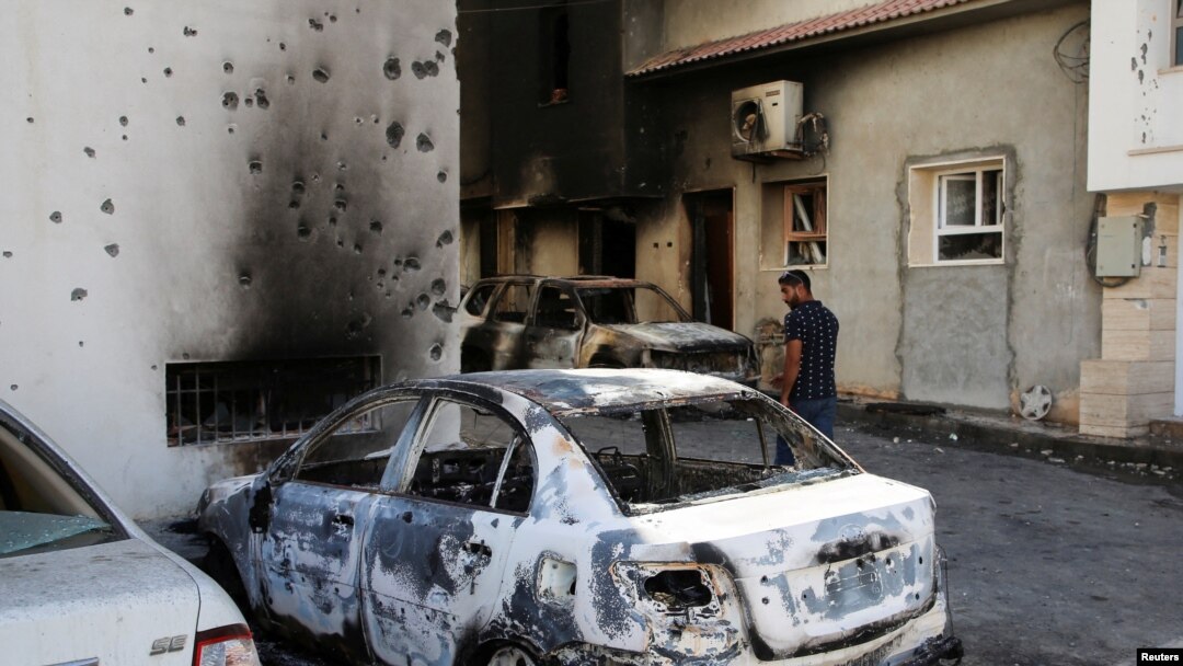 A man looks at a car burned during yesterday's clashes in Tripoli, Libya. Taken 8.28.2022.
