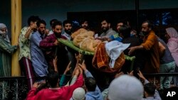 Villagers carry the body of Sunil Kumar, a Kashmiri Hindu man, outside his home at Chotigam village, Indian-administered Kashmir, Aug. 16, 2022. Kumar was shot dead by suspected rebels, while his brother was injured in the attack.