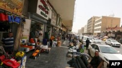 Iraqi vendors wait for customers in the capital Baghdad, Aug. 13, 2022.