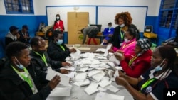 FILE - Election officials count votes at a polling station in Kilimera Primary School in Nairobi, Kenya, Aug. 9, 2022.