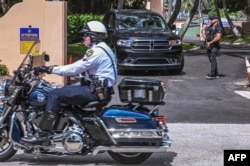 FILE - Secret Service and local law enforcement officers are seen in front of the home of former President Donald Trump at Mar-A-Lago in Palm Beach, Florida on Aug. 9, 2022.