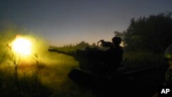 Ukrainian servicemen fire to Russian positions from anti-aircraft gun in Kharkiv region, Ukraine, Aug. 24, 2022.