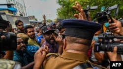 University students and demonstrators argue with police during a protest against the Sri Lankan government and for the release of student leaders in Colombo on Aug. 30, 2022.