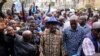 Kenyan presidential candidate Raila Odinga, center, arrives prior to delivering an address to the nation at his campaign headquarters in downtown Nairobi, Kenya. Kenya is calm a day after Deputy President William Ruto was declared the winner of the narrow