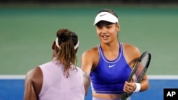 Emma Raducanu of Britain, right, shakes hands with Serena Williams of the United States after their match during the Western & Southern Open tennis tournament, in Mason, Ohio, Aug. 16, 2022.