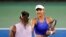 Emma Raducanu of Britain, right, shakes hands with Serena Williams of the United States after their match during the Western & Southern Open tennis tournament, in Mason, Ohio, Aug. 16, 2022.