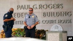 FILE - Law enforcement stands outside of the Paul G. Rogers Federal Courthouse, in West Palm Beach, Florida, Aug. 18, 2022.