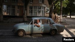 Sergey gestures as he drives his car in Bakhmut in the Donetsk region of Ukraine as Russia's invasion of Ukraine continues on Aug. 14, 2022. "They shoot all day and night, and I cannot sleep," Sergey says.
