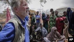David Beasley, left, meets with villagers in the village of Wagalla in northern Kenya Friday, Aug. 19, 2022
