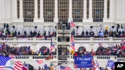 FILE - Insurrectionists loyal to President Donald Trump breach the Capitol in Washington, Jan. 6, 2021. Daniel “D.J.” Rodriguez, a California man who drove a stun gun into a police officer's neck during the riot, was sentenced June 21, 2023, to more than 12 years in prison. 