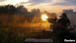 A Ukrainian serviceman fires with a ZU-23-2 anti-aircraft cannon at a position near a front line in the Kharkiv region, as Russia's attack on Ukraine continues, Aug. 10, 2022.