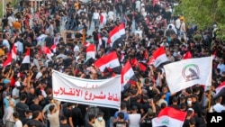 Supporters of the Iran-backed Shiite Coordination Framework rally on Aug. 12, 2022, to denounce the followers of influential Shiite cleric Muqtada al-Sadr who stormed the parliament last month and have since been holding a sit-in outside the assembly building in Baghdad. 