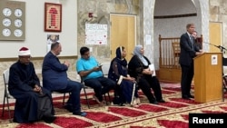 Albuquerque Mayor Tim Keller speaks to an interfaith memorial ceremony at the New Mexico Islamic Center mosque to commemorate four slain Muslim men, hours after police said they had arrested a prime suspect in the killings, in Albuquerque, N.M., Aug. 9, 2022.