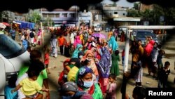 বাংলাদেশের ঢাকার করাইল বস্তির পল্লীবন্ধু এরশাদ স্কুলে করোনভাইরাস এর ভ্যাকসিন পাওয়ার জন্য একটি সারিতে দাঁড়িয়ে আছে বস্তিবাসীরা। (ফাইল ছবি) 