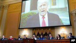 FILE - A video of President Donald Trump is shown on a screen, as the House select committee investigating the January 6 attack on the U.S. Capitol holds a hearing at the Capitol in Washington, July 21, 2022.